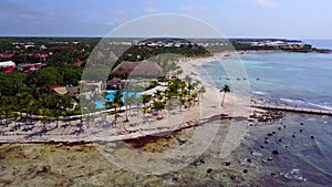 Aerial drone shot. Aerial view from above, birde eye view at an luxury resort hotel beach of a tropical coast. Turquoise