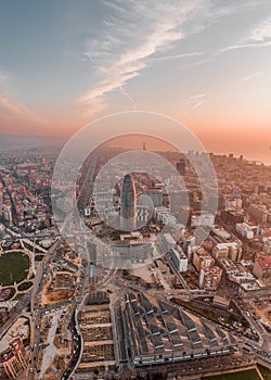 Aerial drone shot of agbar tower by Barcelona beach with sunrise