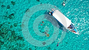 Aerial Drone Shot of Boat with Snorkelers out on the coral reef in Menjangan island, Bali, Indonesia