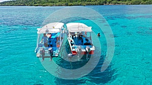 Aerial Drone Shot of Boat with Snorkelers out on the coral reef in Menjangan island, Bali, Indonesia