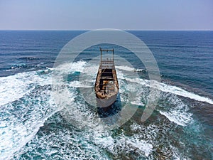 Aerial drone shot of cargo shipwreck in Paphos with waves Cyprus island storm Mediterranean sea