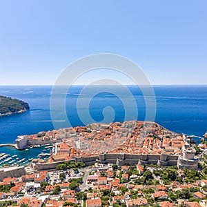 Aerial drone shot of City Walll Dubrovnik by Adriatic sea in Croatia summer noon
