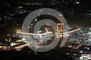 aerial drone shot of clock tower ghanta ghar at night in jodhpur with lights from traffic around