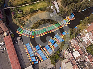 Aerial Drone Shot of Colorful Boats in Xochimilco. Tours by cannels with floating gardens in Mexico City CDMX, Mexico