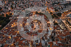 Aerial drone shot of Diocletian Palace at dusk in Split old town with lights before sunrise in Croatia