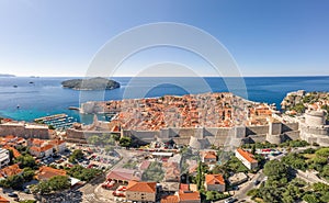 Aerial drone shot of Dubrovink city old town with view of Lokrum island in Croatia summer morning