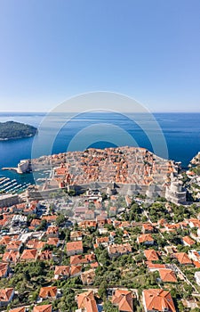 Aerial drone shot of Dubrovink city old town with view of Lokrum island in Croatia summer morning