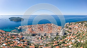 Aerial drone shot of Dubrovink city old town with view of Lokrum island in Croatia summer morning