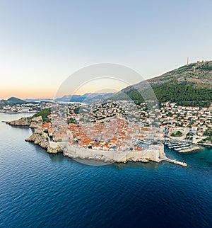 Aerial drone shot of Dubrovnik city wall in Adriatic sea in Croatia summer with view of Mountain Srd before sunrise