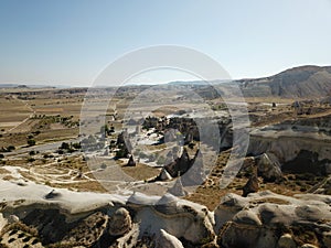 Aerial drone shot of the Fairy Chimneys over the landscape of Goreme, Cappadocia.