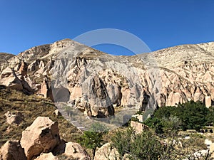 Aerial drone shot of the Fairy Chimneys over the landscape of Goreme, Cappadocia.