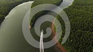 Aerial drone shot fly tracking a boat on a river, Phang Nga bay, Thailand