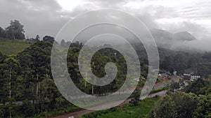 Aerial Drone Shot Flying by Cloudy Misty Foggy Lushoto village in Usambara Mountains. Remote Place in Tanga Province