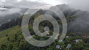 Aerial Drone Shot Flying by Cloudy Misty Foggy Lushoto village in Usambara Mountains. Remote Place in Tanga Province