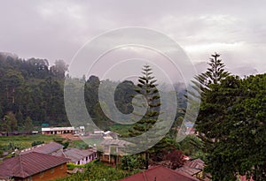 Aerial Drone Shot Flying by Cloudy Misty Foggy Lushoto village in Usambara Mountains. Remote Place in Tanga Province