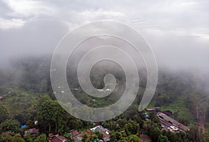 Aerial Drone Shot Flying by Cloudy Misty Foggy Lushoto village in Usambara Mountains. Remote Place in Tanga Province