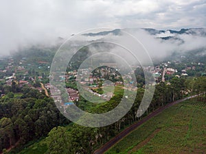 Aerial Drone Shot Flying by Cloudy Misty Foggy Lushoto village in Usambara Mountains. Remote Place in Tanga Province