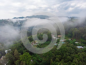 Aerial Drone Shot Flying by Cloudy Misty Foggy Lushoto village in Usambara Mountains. Remote Place in Tanga Province