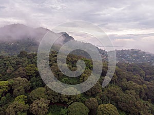 Aerial Drone Shot Flying by Cloudy Misty Foggy Lushoto village in Usambara Mountains. Remote Place in Tanga Province