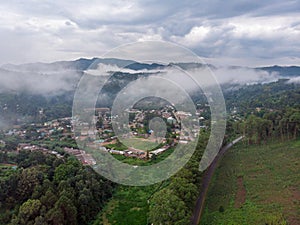 Aerial Drone Shot Flying by Cloudy Misty Foggy Lushoto village in Usambara Mountains. Remote Place in Tanga Province