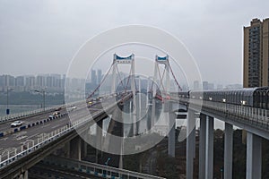 Aerial drone shot of flyover highway to E`GongYan Bridge with Chinese name on the bridge in Chongqing, China
