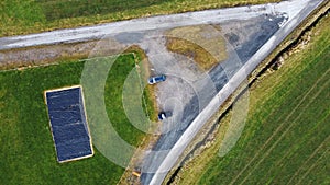 Aerial drone shot of a fork in the road in a meadow in Germany in December