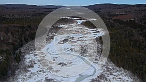 Aerial Drone shot of frozen river in Upstate New York during the winter