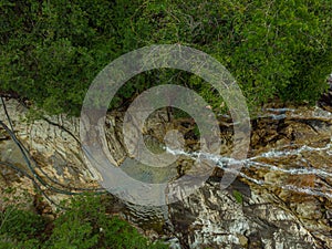 Aerial drone shot of a hidden waterfall in the jungle which is located in Buntong Waterfall, Perak, Malaysia.