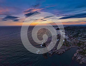 Aerial drone shot of a magical sunset over the ocean washing the Southeast coast of Norway