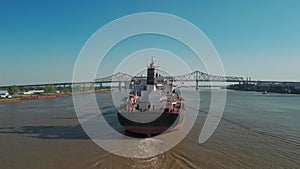 Aerial drone shot of Mississippi River waterfront and bridge in New Orleans, Louisiana