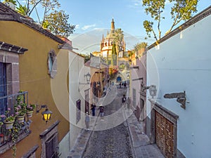 Aerial Drone Shot From Narrow street in San Miguel de Allende Cathedral at evening light in Guanajuato, Mexico
