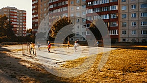 Aerial Drone Shot of Neighborhood Friends Playing Soccer Outside in Urban Backyard. Multicultural