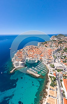 Aerial drone shot of Old Port in east Dubrovnik old town in Croatia summer noon