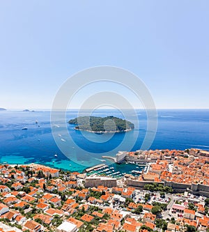 Aerial drone shot of Otok Lokrum in Adriatic sea near Dubrovnik old town in Croatia summer noon