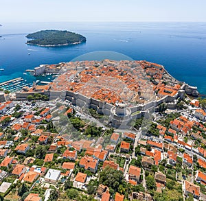 Aerial drone shot of Otok Lokrum in Adriatic sea near Dubrovnik old town in Croatia summer noon