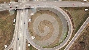 Aerial drone shot over road interchange, symmetric, bridges and moving vehicles