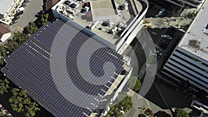 Aerial, drone shot panning over roof full of Solar panels, sunny day, Long Beach