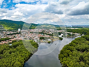 Aerial drone shot of river, heavy density mangrove and gated community photo