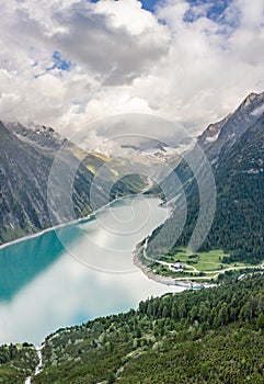 Aerial drone shot of Schlegeisspeicher resevoir with galcier view at dusk