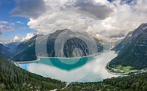 Aerial drone shot of Schlegeisspeicher resevoir with galcier view at dusk