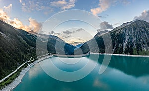 Aerial drone shot of Schlegeisspeicher resevoir with galcier view at dusk