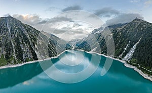 Aerial drone shot of Schlegeisspeicher resevoir with galcier view at dusk