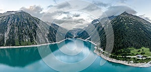 Aerial drone shot of Schlegeisspeicher resevoir with galcier view at dusk