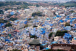 aerial drone shot showing jodhpur blue city cityscape showing traditional houses in middle of aravalli with colorful