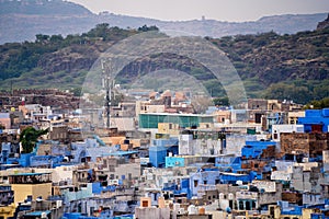 aerial drone shot showing jodhpur blue city cityscape showing traditional houses in middle of aravalli with colorful