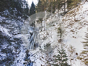 Aerial drone shot of snowy and icy winter landscape in the oetschergraeben in austria