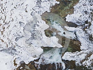 Aerial drone shot of snowy and icy winter landscape in the oetschergraeben in austria