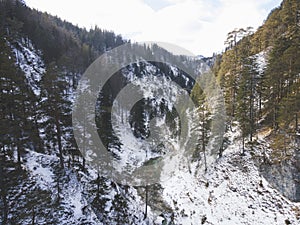 Aerial drone shot of snowy and icy winter landscape in the oetschergraeben in austria