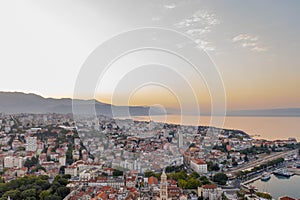 Aerial drone shot of Split city in sunrise hour with view of Mount Morso in Croatia