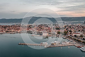 Aerial drone shot of Split old town ferry port with lights before sunrise in morning in Croatia